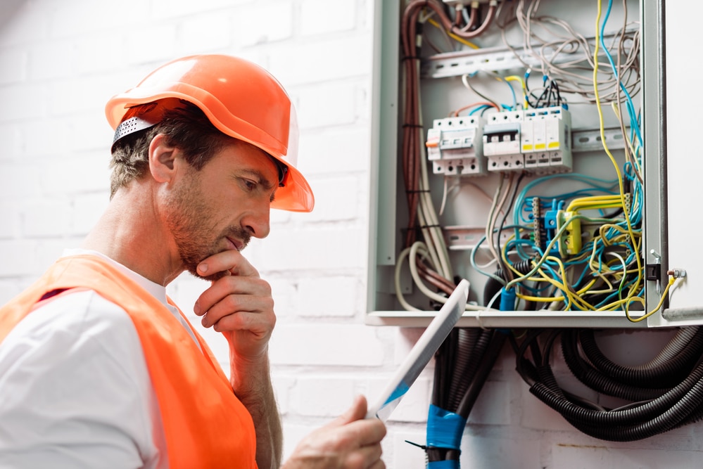 Electrician working on electrical panel