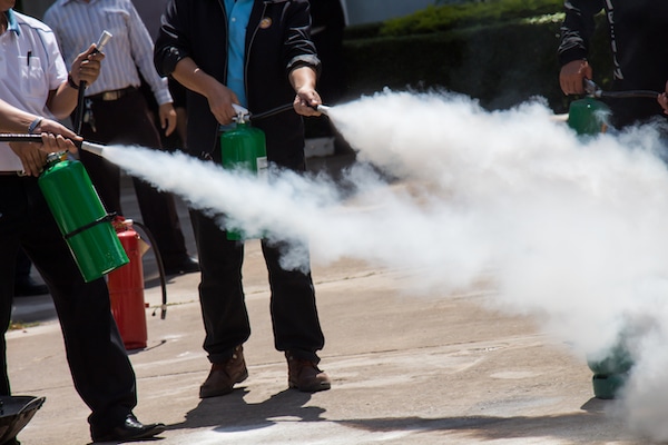 Group of Employees Learning how to use a fire extinguisher