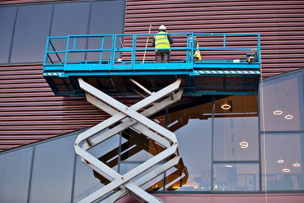 Man Cleaning Windows on Scissor Lift