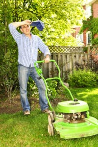 Man Sweating while mowing lawn