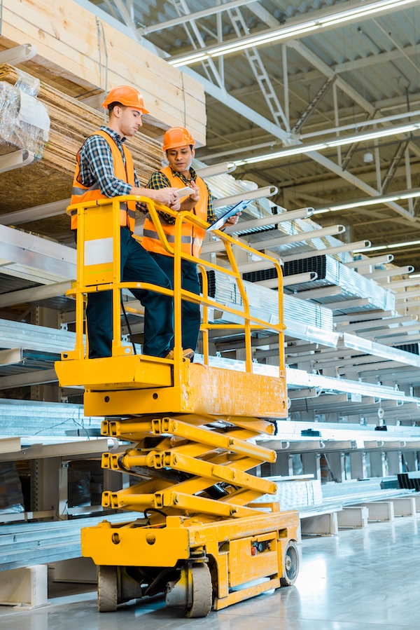 2 men in a scissor lift bucket