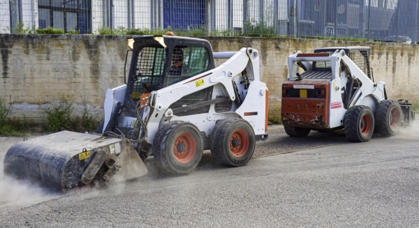 Skid Steer With Sweeper Attachment