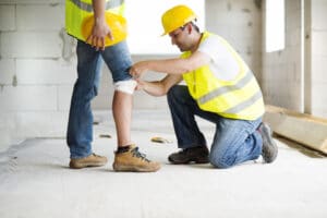 Worker Bandaging a Bloody Knee