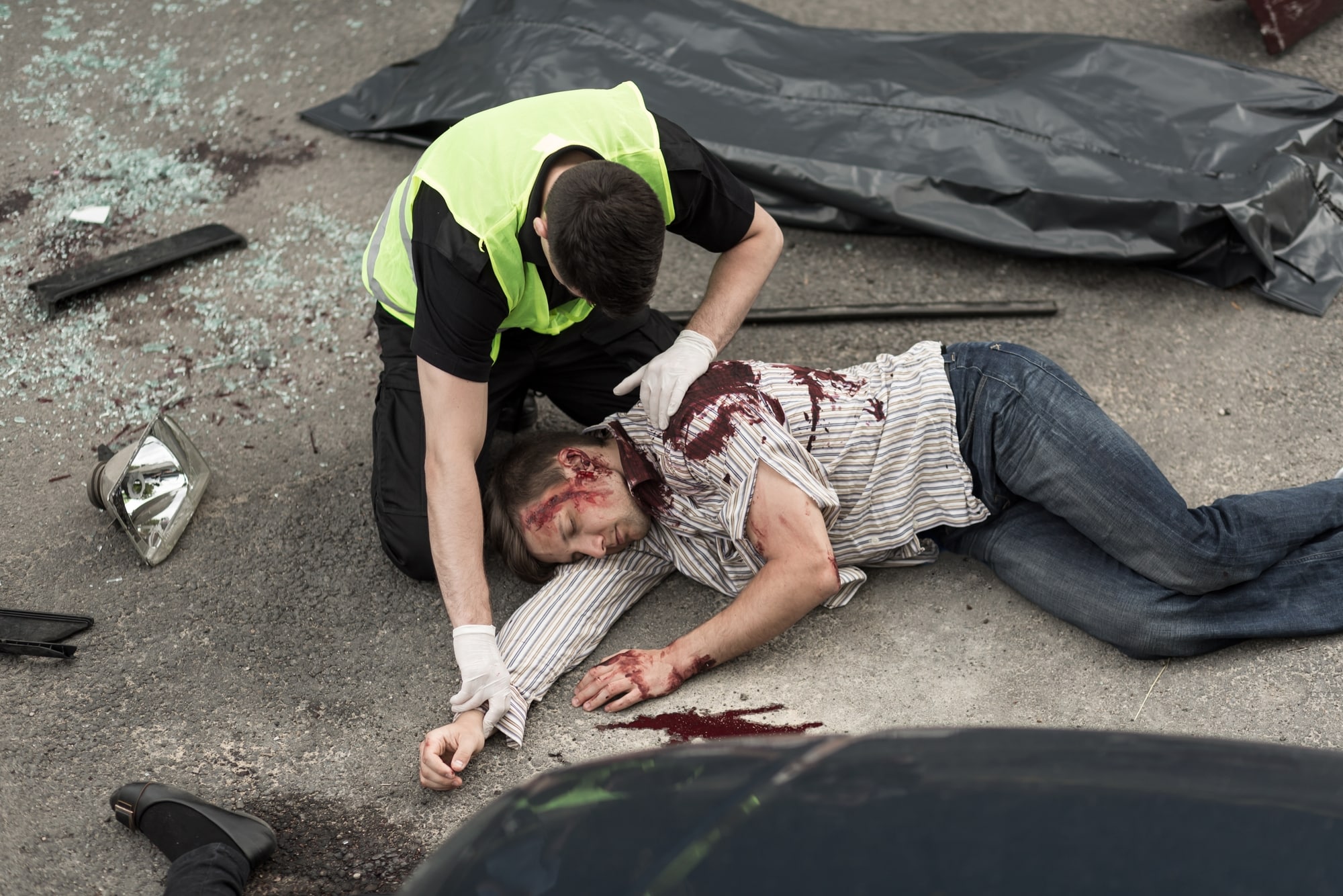 Man Laying on Ground In Bloody Accident