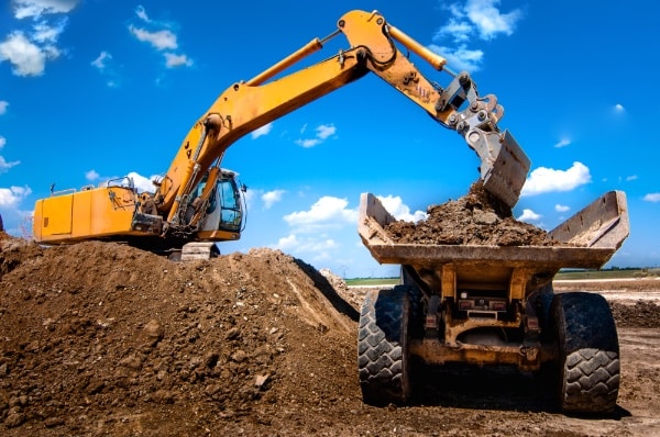 Excavator Load Dumped Into Dump Truck