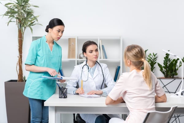 Female Nurses Discussing Patient Care