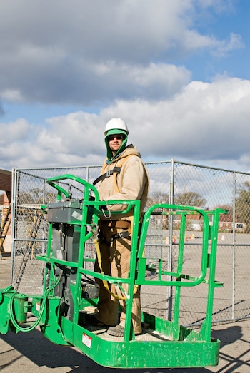 Worker in an aerial lift bucket