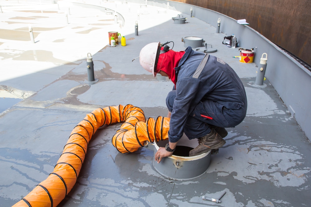 Man using ventilation in a confined space prior to entry