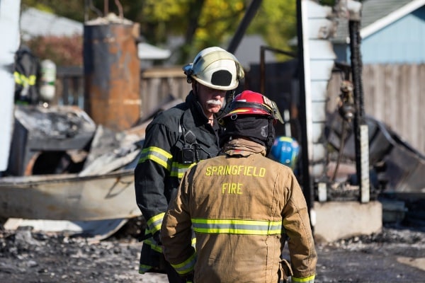 Burned Down Building with Firefighters Standing By