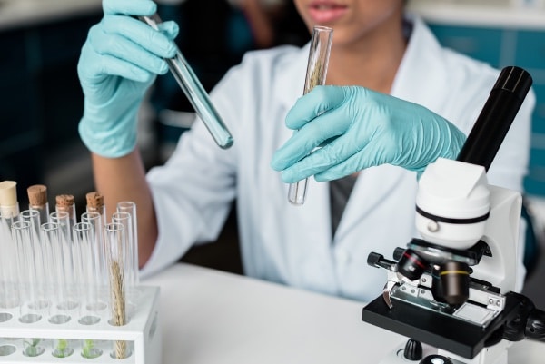 Female Lab Worker With Chemical Vials