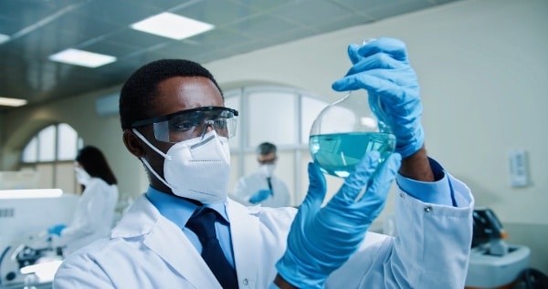 Scientist With a Beaker of Chemicals