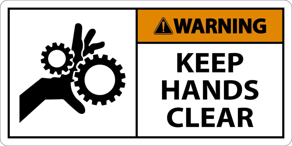 A warning sign with the words keep hands clear.