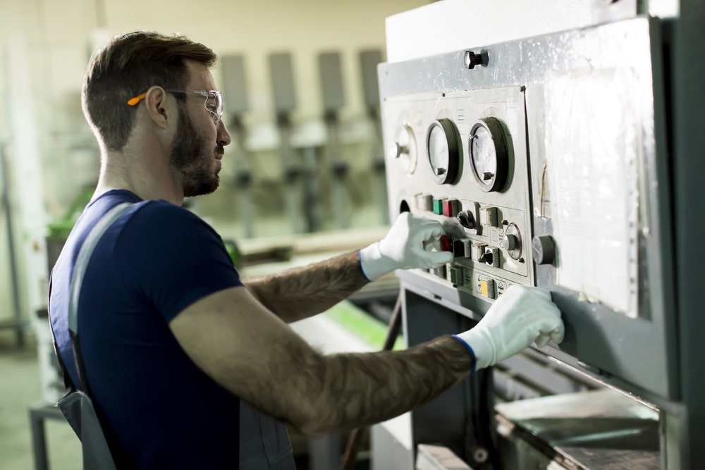 A man working on a machine in a factory.