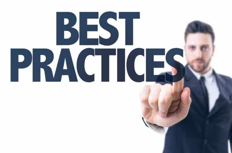 A man in a suit pointing to the word "best practices."