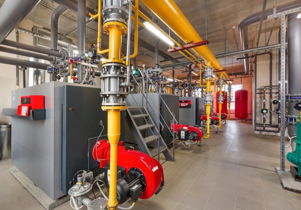 A room full of pipes and valves in a building.