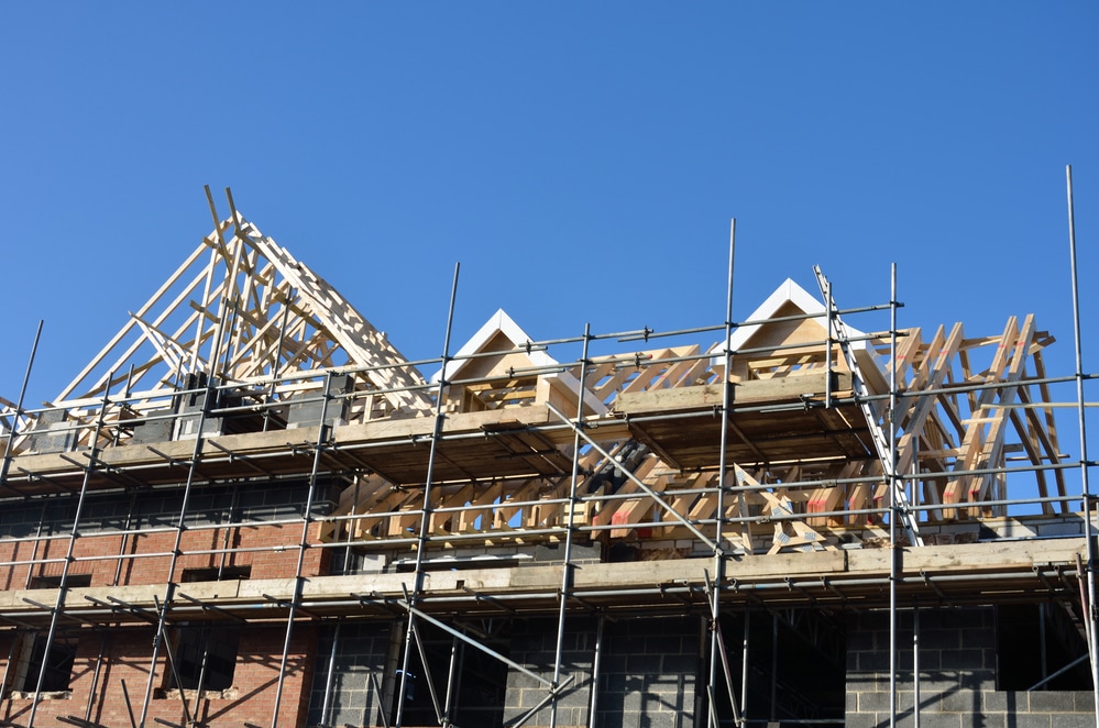 A house under construction with scaffolding.