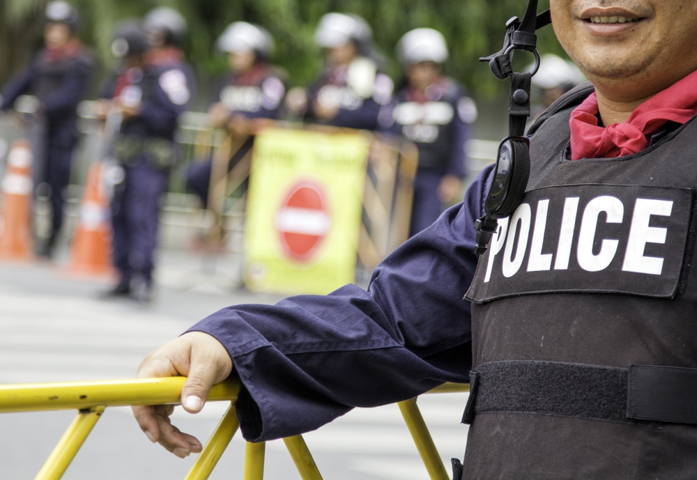 A man wearing a police vest standing outside an active shooter scenario