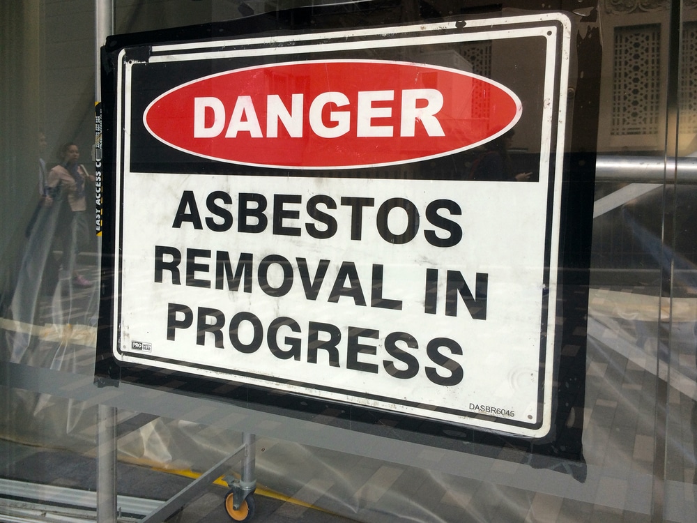 A sign that says danger asbestos removal in progress.