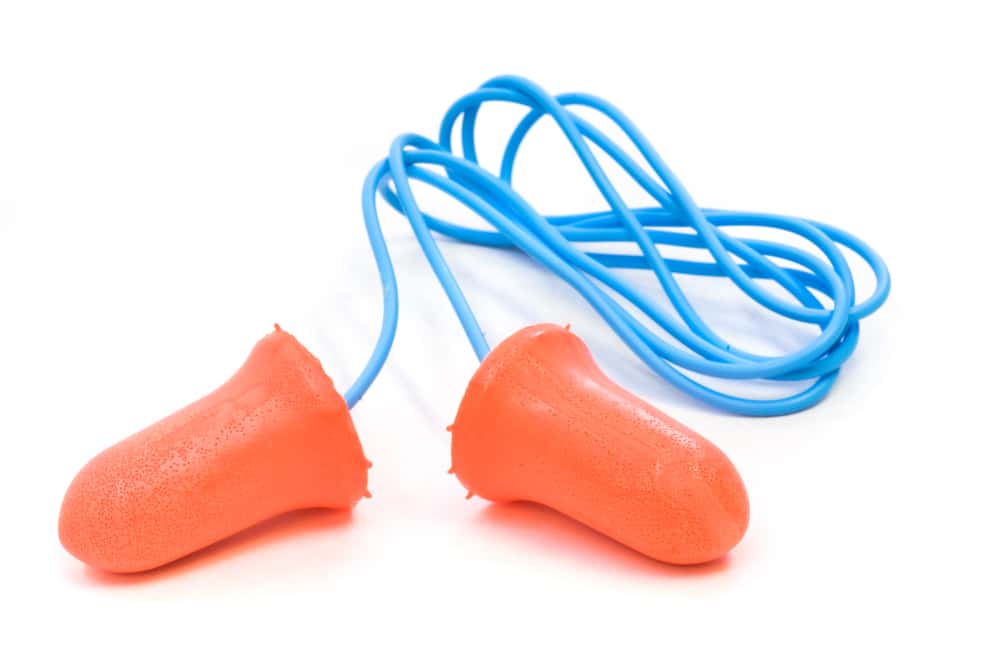 A pair of orange and blue ear plugs on a white background.